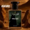 A perfume bottle of named wild aura placed while the background represents rocks and mountains giving an urban desert vibe.
